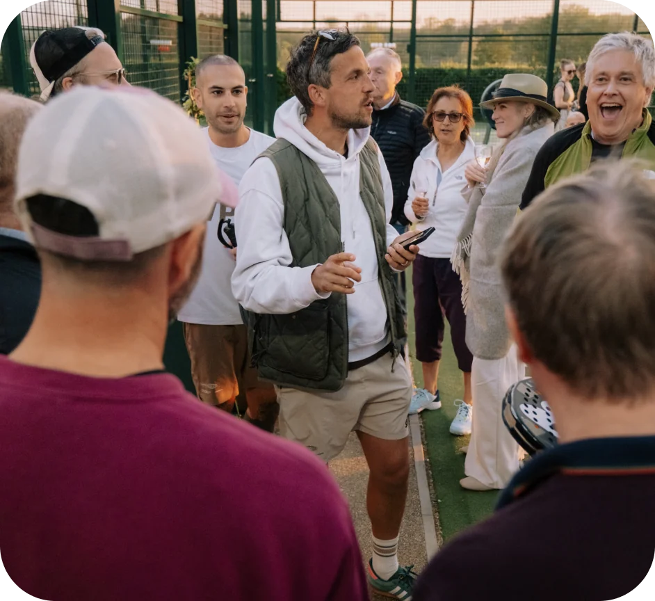 Club staff talking with players on court