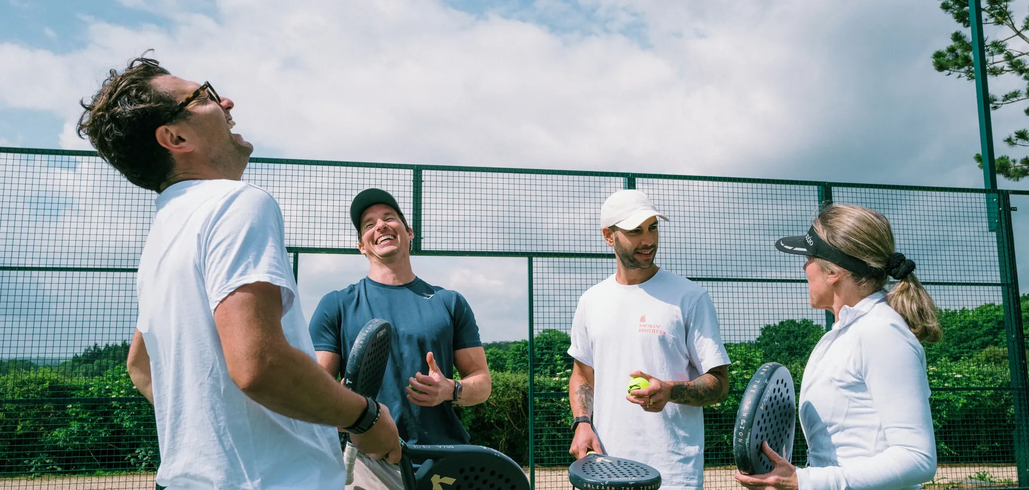 Players laughing together on court at a Nettla club